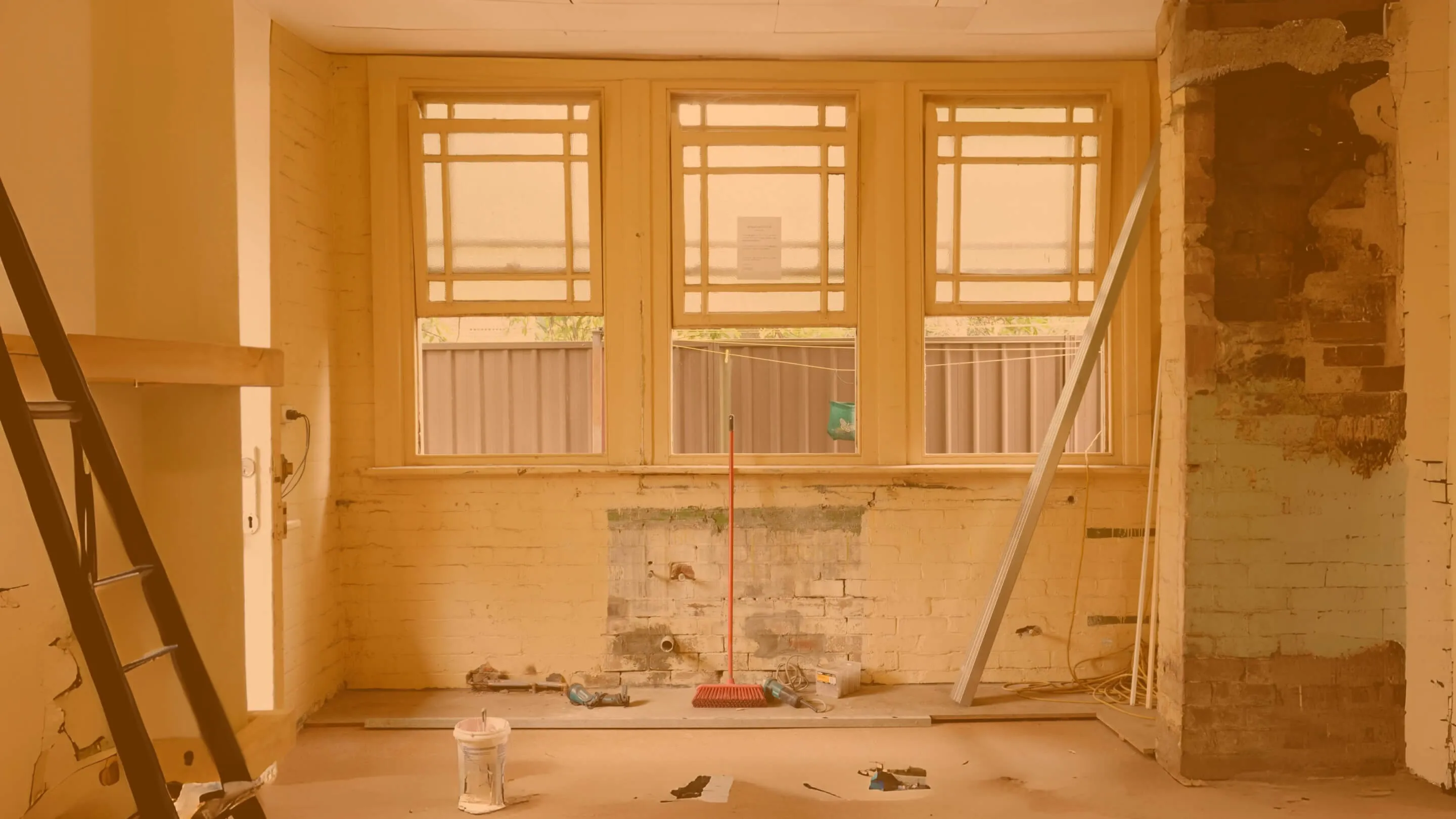 an empty room with windows that is being renovated